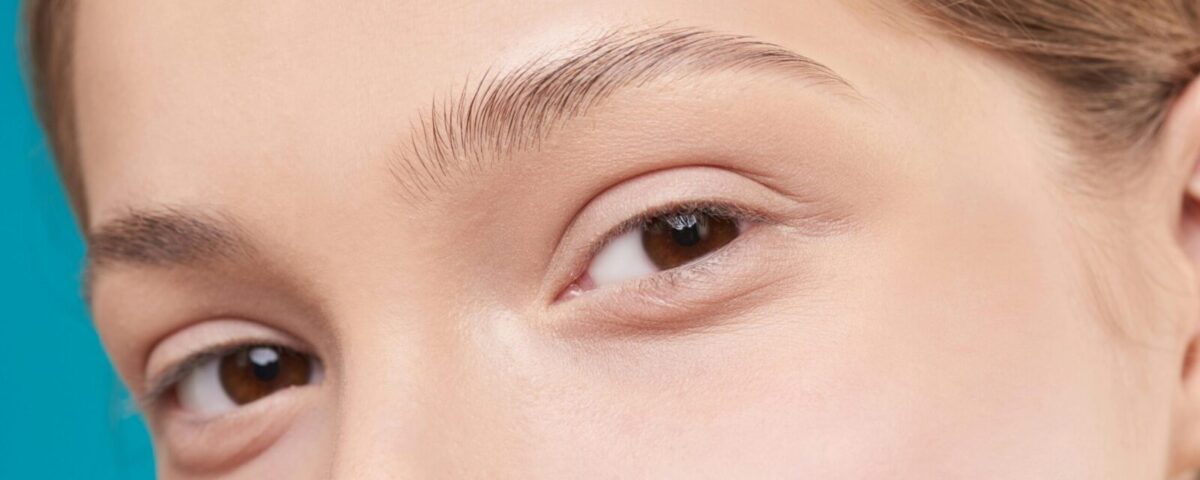 A close-up photo showcasing a woman's natural skin and eye detail, emphasizing natural beauty.