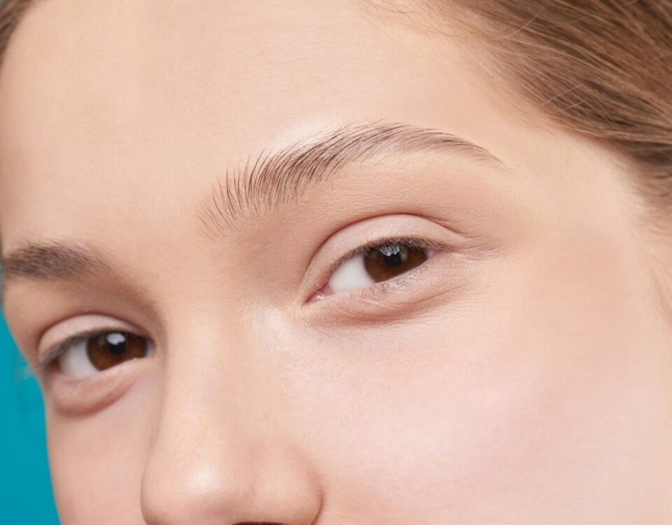 A close-up photo showcasing a woman's natural skin and eye detail, emphasizing natural beauty.